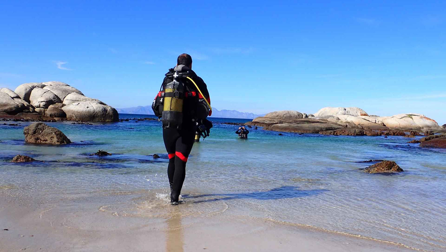 Diver walking into the water at windmill beach