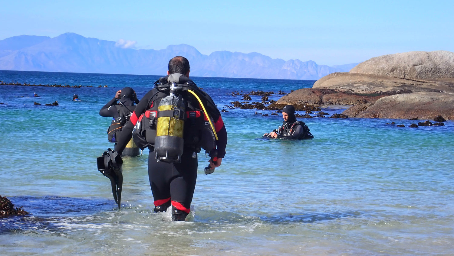 Divers entering the water at windmill beach