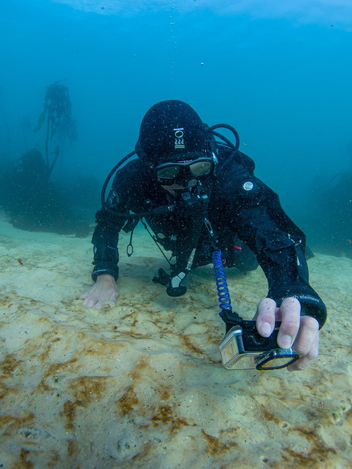 Open water diver taking photos with his