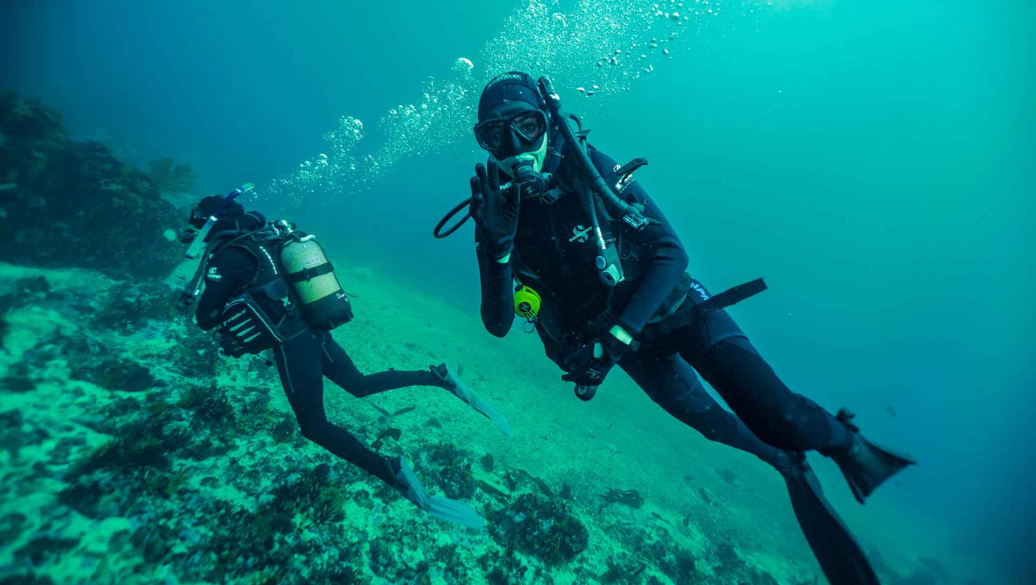 Scuba divers gliding over the reef with great buoyancy controll