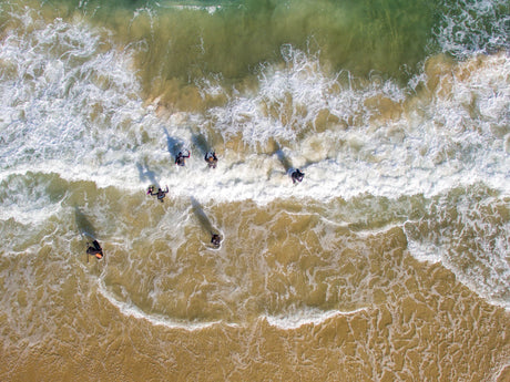 Freedivers going through the surf