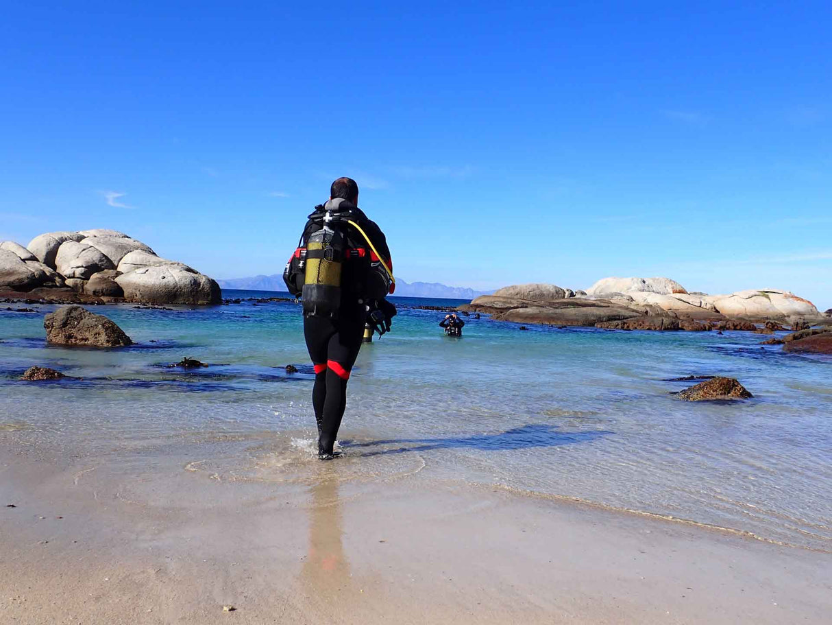 Divers entering the water at windmill beach for a shore dive