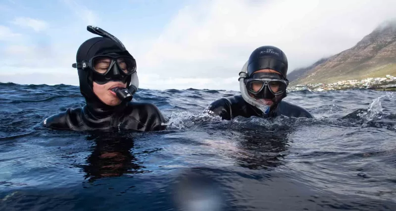 Freedivers on the surfaces with masks and snorkels